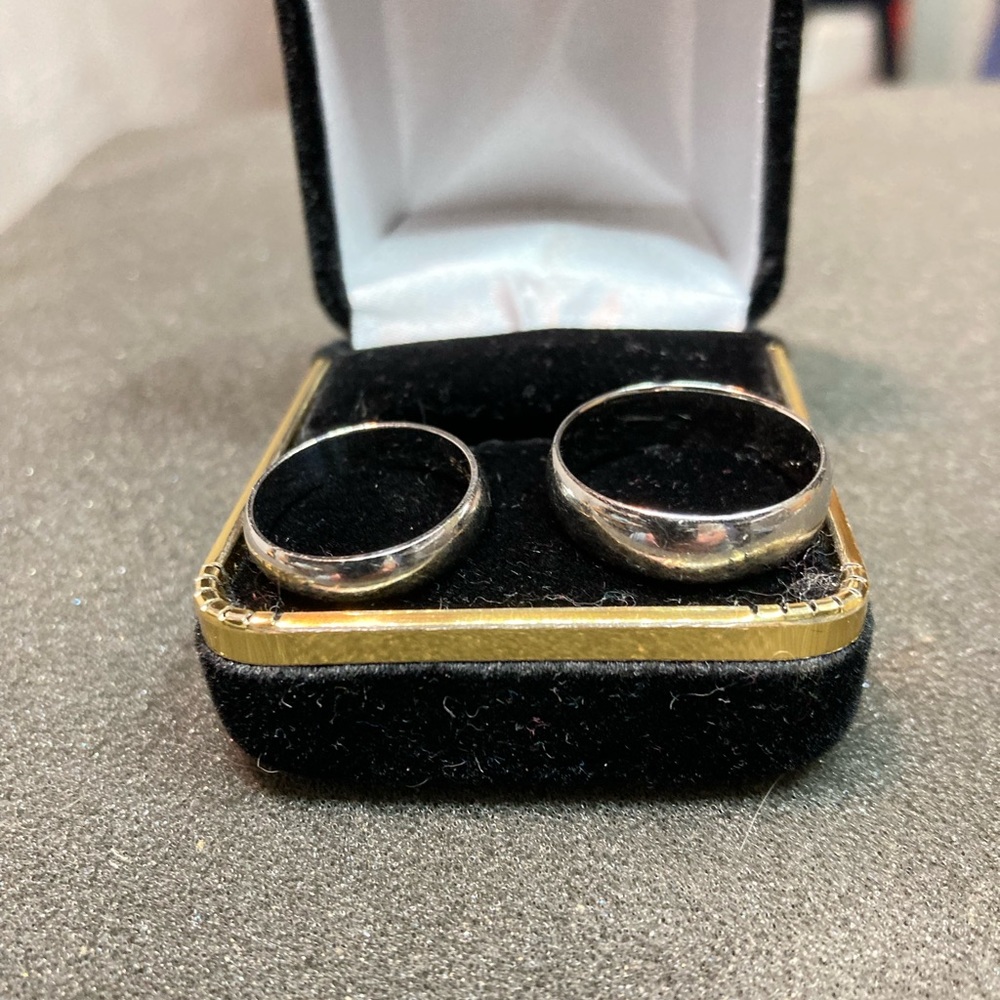 A pair of wedding rings.  His and hers white gold wedding bands.